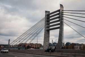 A striking cable-stayed bridge with vehicles, showcasing urban architecture in a city setting.