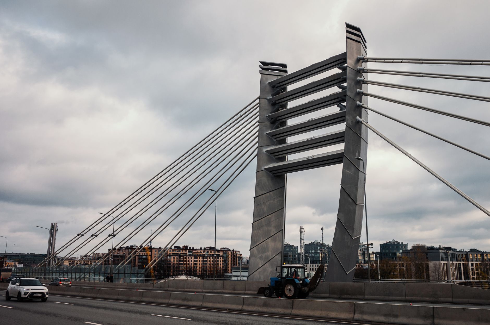 A striking cable-stayed bridge with vehicles, showcasing urban architecture in a city setting.