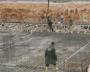 Workers building a foundation with rebar at a construction site.