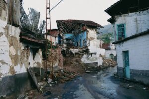 A devastated urban street in Malatya, Turkey after an earthquake, showcasing collapsed traditional houses.