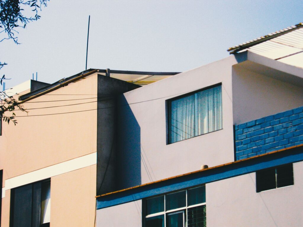 Architectural detail of a modern building with vibrant facades and clear blue sky.