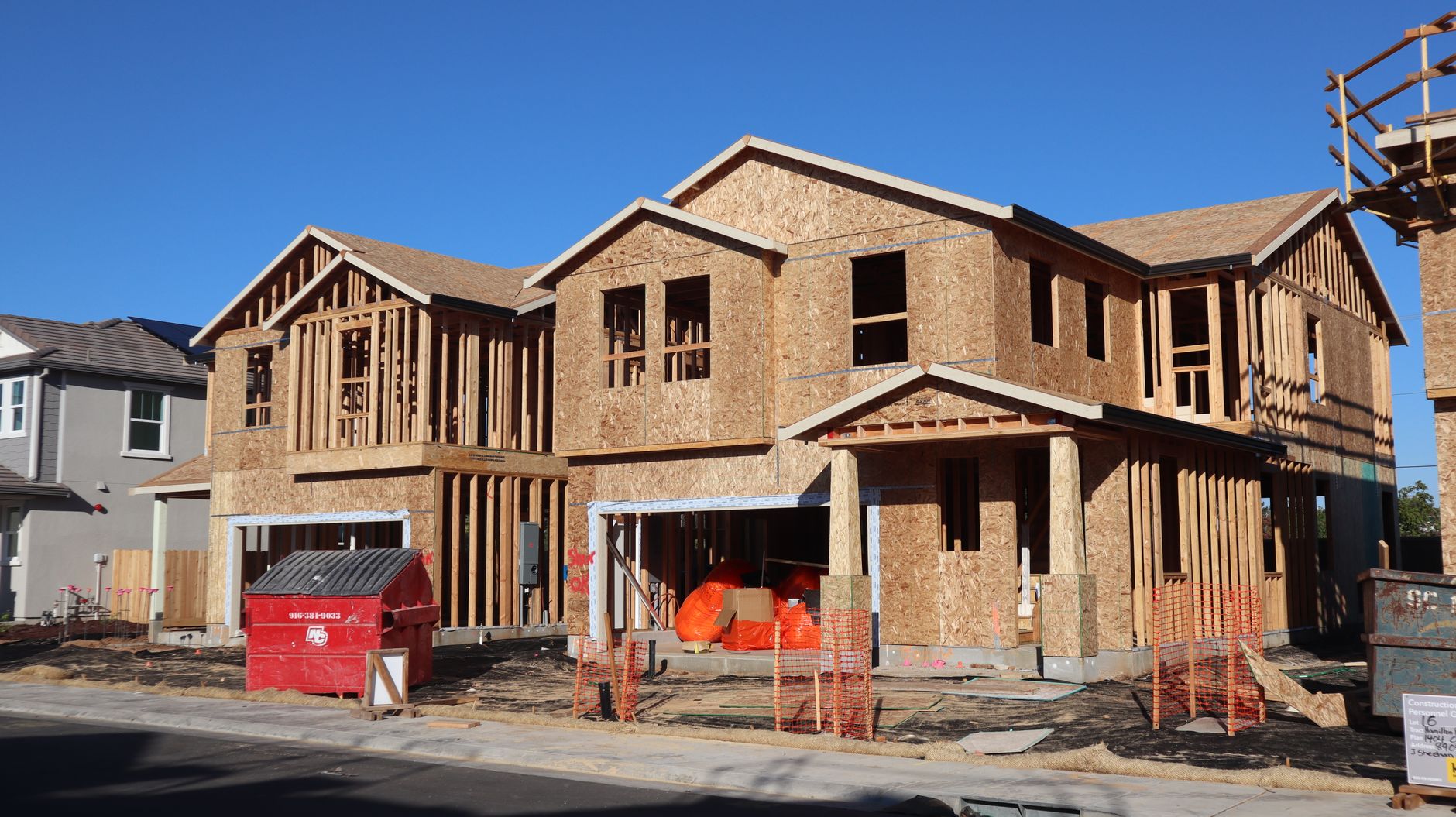 Wooden frames of new houses under construction in Elk Grove subdivision.