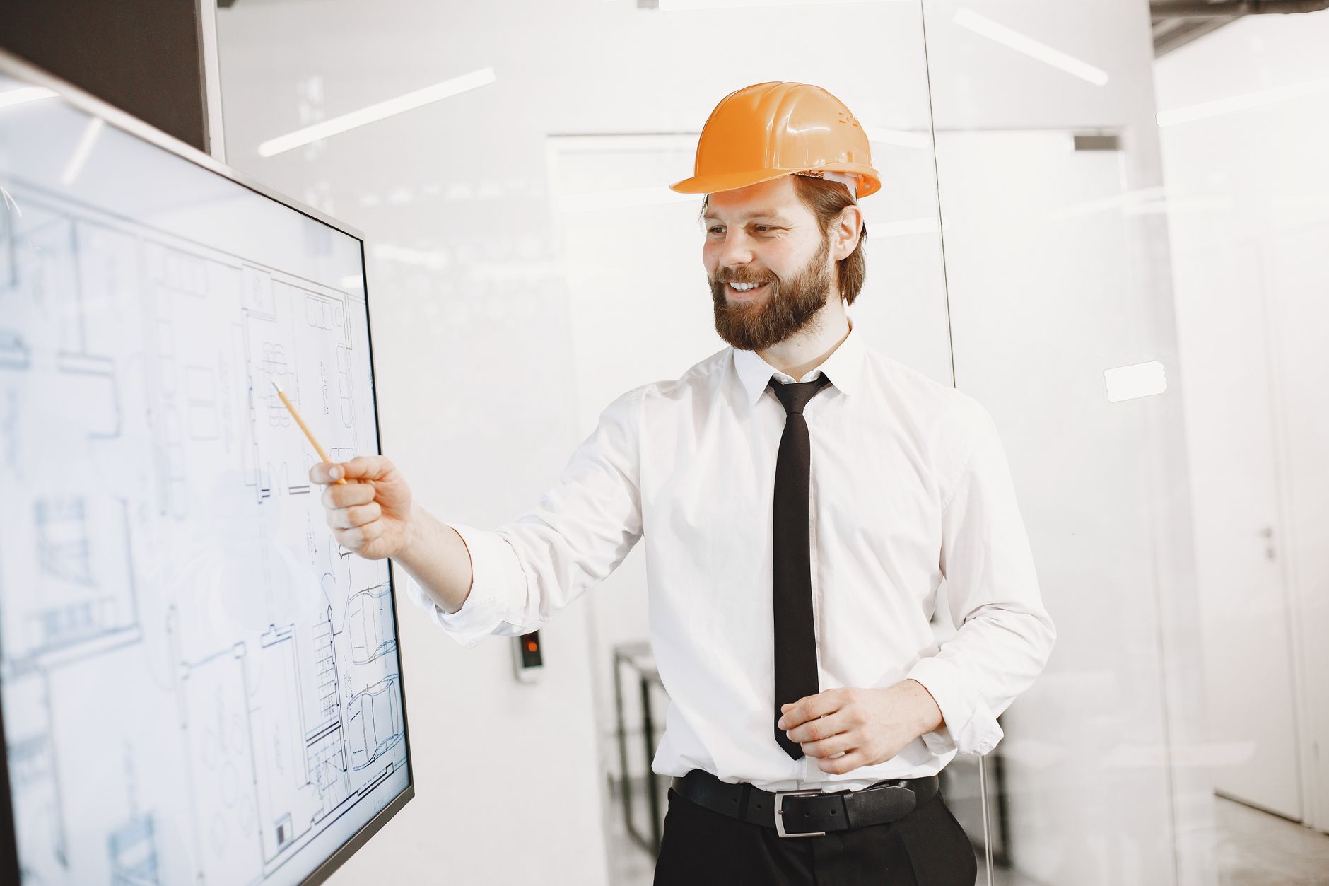 Professional engineer explains blueprint on digital screen in modern office.