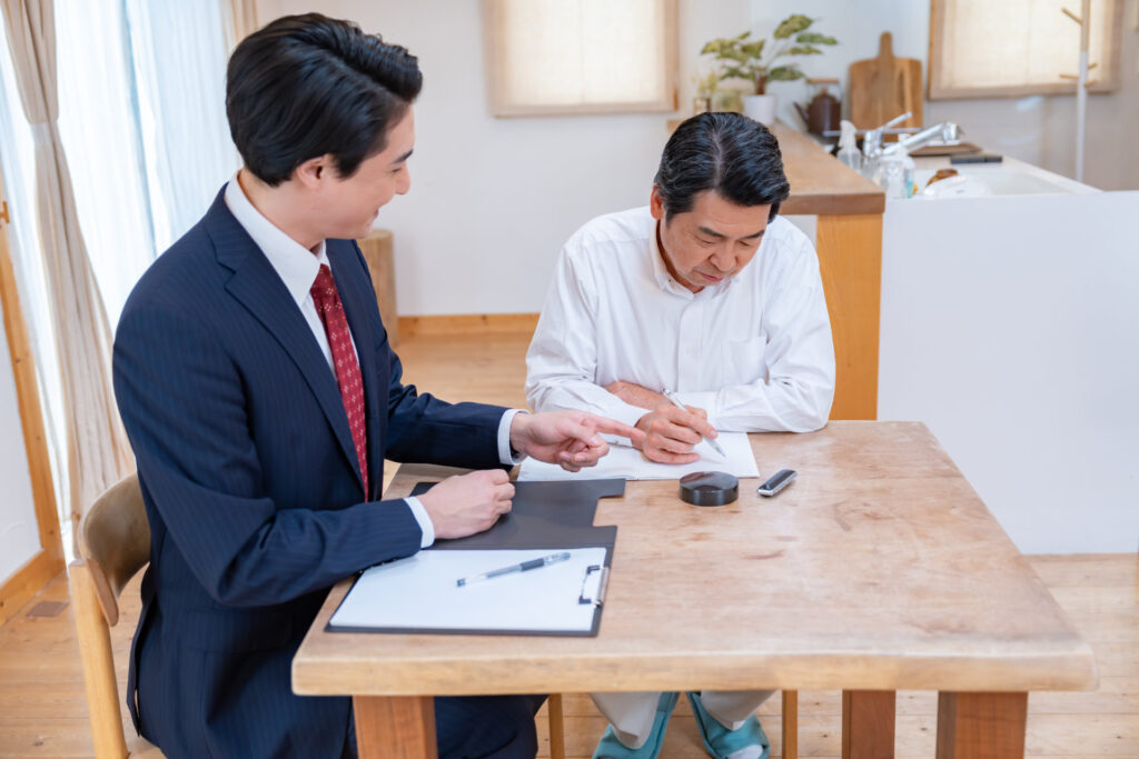 自宅のテーブルで施主と工事の順番を決める担当者